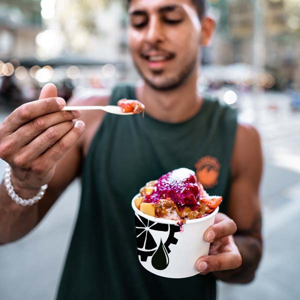 acai bowl man eating outside urban juicer